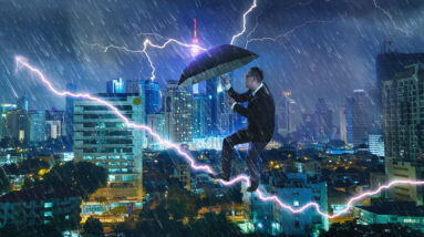 graphicstock young businessman with umbrella against thunderstorm overcoming challenges and crisis concept mixed media ru5M 3vgig